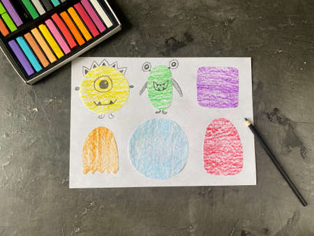 Draw funny monsters on paper with a pencil. Lesson learning for children.の写真素材
