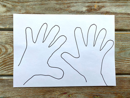 Painted palms with a marker on white paper.の写真素材