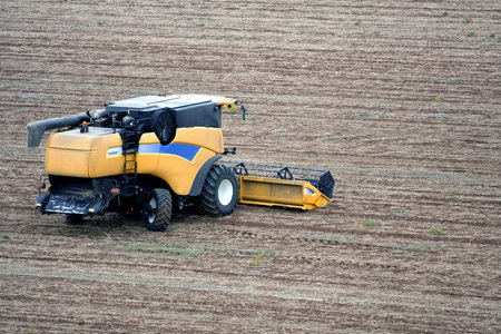 Aerial landscape with rural field and tractor at hot summer