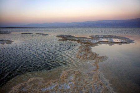 The water of the dead sea with the Jordan mountains at sunsetの写真素材