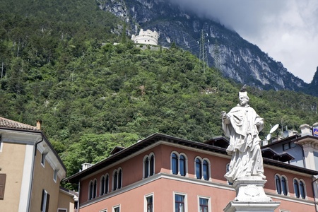 Statue and castle in the Riva del Garda town in the northern Italy mountains on Garda lakeの写真素材