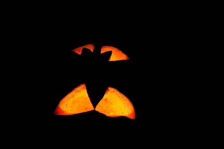 Halloween pumpkin at an entrance to a house in darknessの写真素材