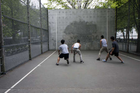 A group of boys play handball in a city facilityのeditorial素材