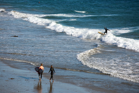 Surfers on the beach in Californiaの写真素材