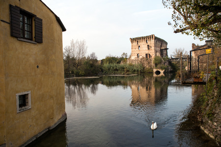 Old castle and bridge in Italian town Borghettoのeditorial素材