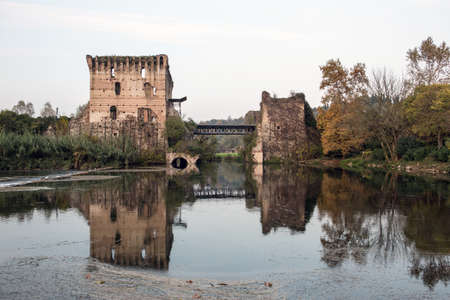 Old castle and bridge in Italian town Borghettoのeditorial素材