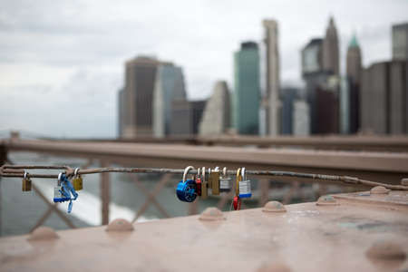 New York City buildings from Brooklyn bridge with locks on wireのeditorial素材