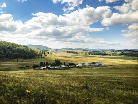 Landscape of the village in a valley between mountainsの写真素材