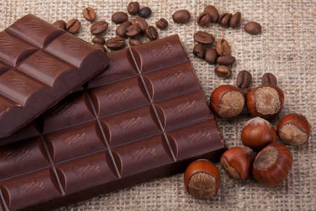 two bars of dark chocolate, hazelnut and coffee beansの写真素材