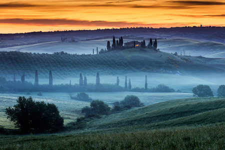A Tuscany villa in the valley at sunriseの写真素材