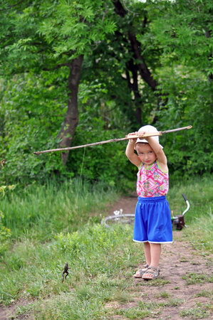 Little boy caught a frog instead of fish