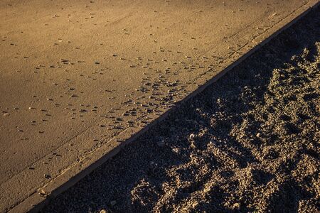 scattered gravel granite on the roadside surface texture industrialの写真素材