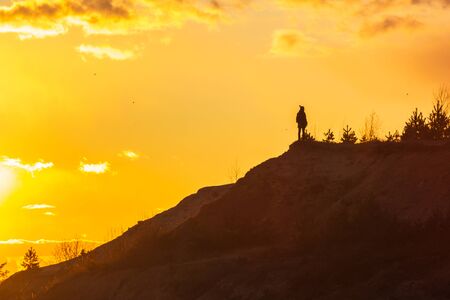 man at the top enjoying the sunset wanderlust happinessの写真素材