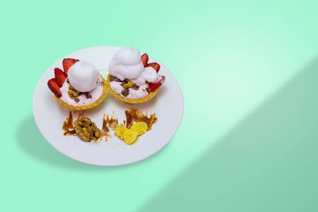 cake on a plate with nuts strawberry with chocolate on the table copy spaceの写真素材