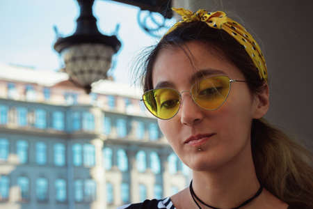 girl portrait hipster trendy street style yellow glasses urban architectureの写真素材