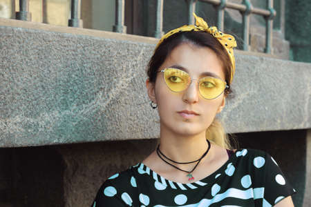 girl portrait hipster trendy street style yellow glasses urban architectureの写真素材