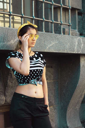 girl hipster trendy street style yellow glasses urban architectureの写真素材