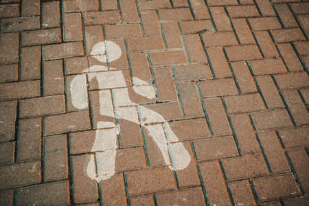 figure of a man on the asphalt footpath surface pedestrianの写真素材