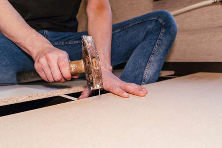spinning bolts master worker man assembling furniture bed components repair tools easyの写真素材