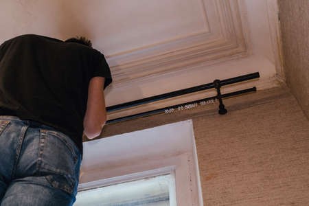 assembling a cornice eaves for curtains designer man workerの写真素材