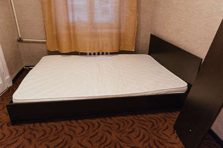 unpacking and assembling furniture components of bed slab particleboard constructの写真素材