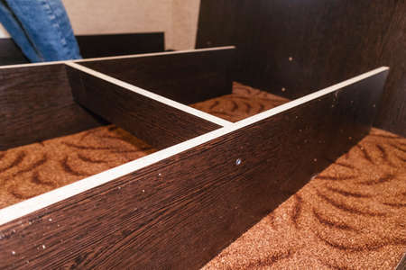 spinning bolts master worker man assembling furniture bed components repair tools easyの写真素材