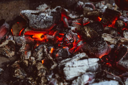 hot red coals in the oven barbecue heat smoulders textureの写真素材