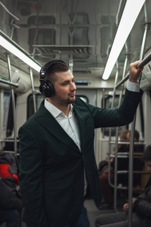 man young male caucasian passenger one person positively cheerful listens to music in headphones,...