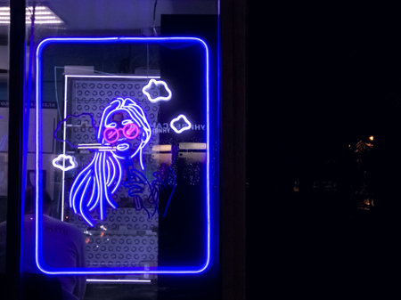 vape shop electronic cigarette neon colored window showcase sign lights glow up attracting customers on the street at night.concept vape shop.の写真素材