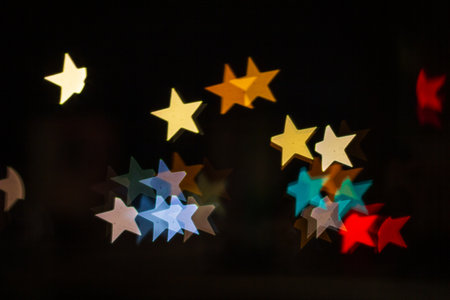 Star shape background bokeh blurred, many objects, colored red yellow orange blue, glow moving, car lights on the road blur, at night. concept background star.の写真素材
