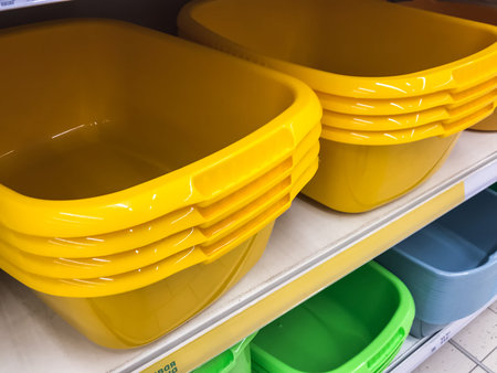 Laundry basins in the store, Yellow Hand Wash , Stacked on Hardware Store Rack .Concept Washingの写真素材