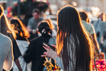 Woman with phone in her hands on street