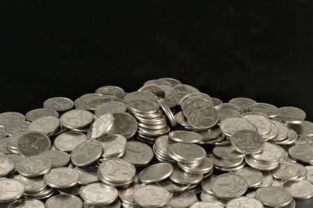 Mountain silver coins on a black background.の写真素材