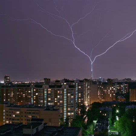 Thunder-storm at night in city. The lightning gets in a television tower.の写真素材