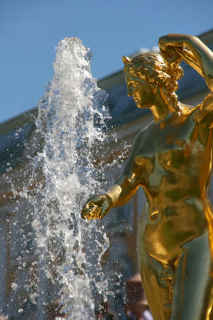 Russia, St. Petersburg, Peterhof, the great cascade fountain complex. Fragment. Statue of a woman on the background of the fountain.の写真素材