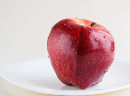 red Apple on white plateの写真素材