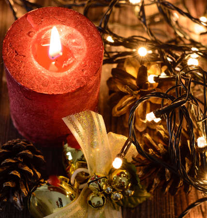 Red christmas candle wiht gift box on dark backgroundの写真素材