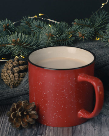 Cacao mug, christmas background with candles and pine cones on christmas tree branch