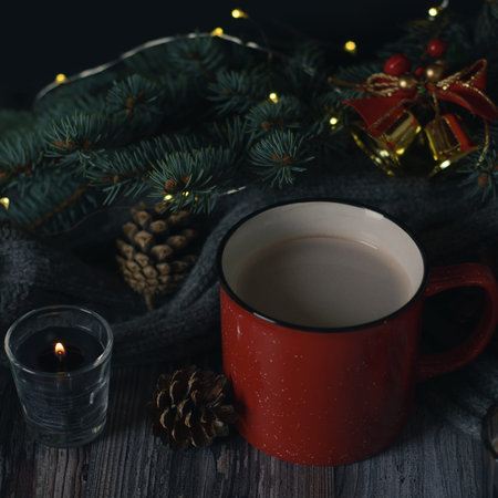 Cacao mug, christmas background with candles and pine cones on christmas tree branch