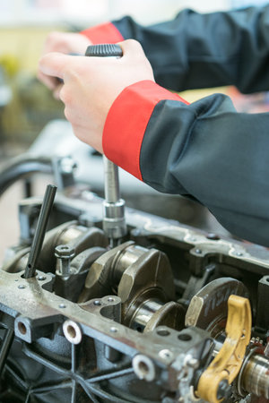 Car mechanic checking the engine
