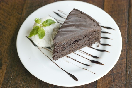 A piece of chocolate cake and vanila ice-cream on white plateの写真素材