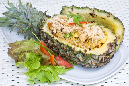 pineapple chicken fried rice serves in pineapple fruit containerの写真素材