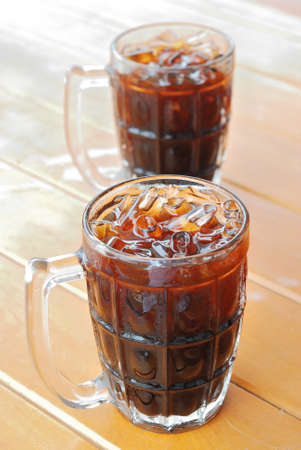 vertical glasses of Thai style ice coffee or  O Lieng on wood tableの写真素材