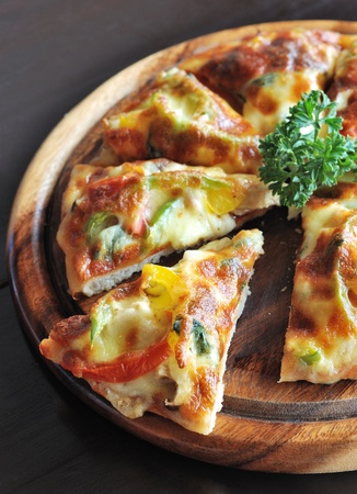 slice of vegetarian pizza on wooden boardの写真素材