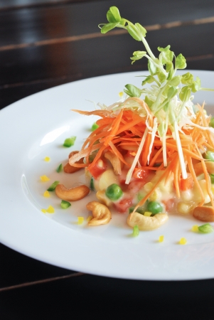 fresh mixed vegetable salad on white dishの写真素材