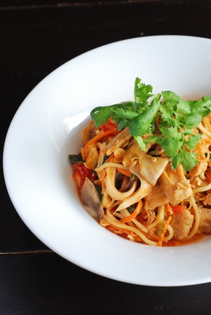 top view spicy vegetarian spahetti in white plate on black tableの写真素材
