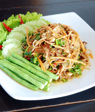 vegetarian hot and spicy salad and gluten imitated meat with fresh mix vegetable on white dishの写真素材