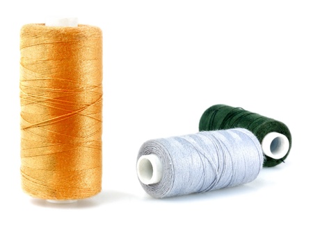 isolated yellow, green and grey threads on white backgroundの写真素材