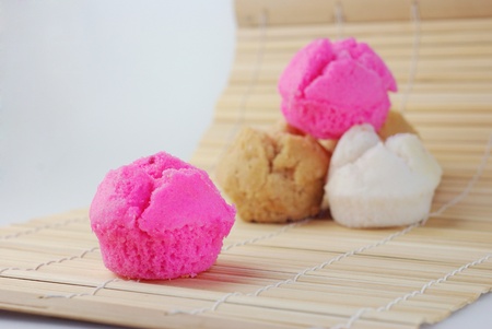 close up pink, brown and white Chinese muffin cake on bamboo mat の写真素材