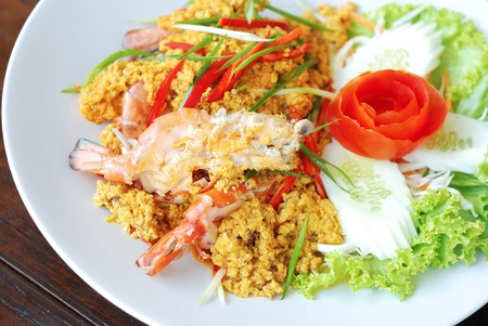 close up stir fried shrimp curry in white dishの写真素材